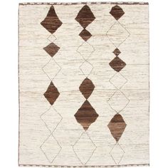 a brown and white rug with diamond shapes on the bottom, in various sizes and colors