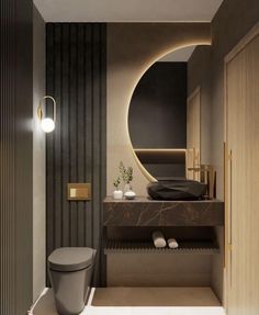 a bathroom with a toilet, sink and large circular mirror in the wall above it