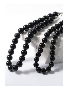 Experience the bold and versatile beauty of our 14mm Black Onyx Beaded Necklace with OT Buckle. This uniquely crafted necklace features large black onyx beads and an OT clasp, creating a statement piece that effortlessly combines boldness with contemporary style. Metal: Recycled Sterling Silver Plated On Brass Gemstone: Black onyx 14mm Length: 420mm Weight: 105g Elegant Black Jewelry With 108 Beads, Elegant Polished Black Beads, Elegant Black Polished Beads, Elegant Black Jewelry With 8mm Beads, Classic Onyx Beaded Necklace With Black Beads, Obsidian Necklace With Black Round Beads, Obsidian Necklace With Round Black Beads, Classic Black Beaded Necklaces, Formal Black Necklace With Gemstone Beads