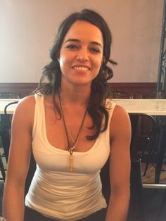 a woman sitting at a table with a plate of food