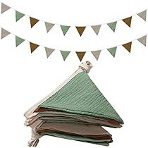 a stack of books sitting on top of a table next to a bunting banner