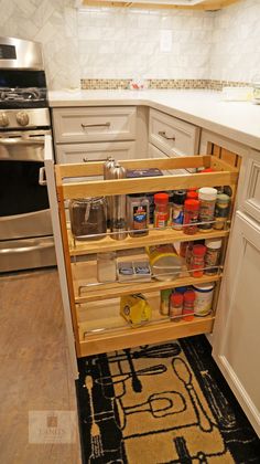 an open cabinet in the middle of a kitchen