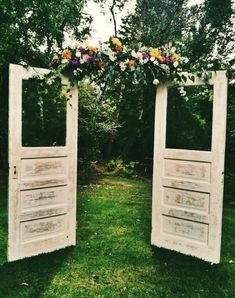 an image of two wooden doors with flowers on them and the words wood door wedding arch