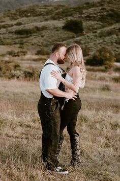 a man and woman standing in the middle of a field