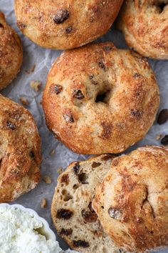 several bagels with raisins and cream on top