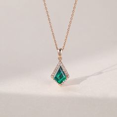 Details – Center Stone: Lab Emerald – Shape: Kite – Size: 7*10 mm – Accent Stone: Moissanite or Natural Diamond – Weight: Approx. 0.12 ct – Metal Material: Available in 14K/18K Solid gold – Metal Color: Available in Rose/Yellow/White Gold – Pendant Size: 20*9.5 mm – Chain Type: Cable Chain – Chain Width: 1.1 mm – Chain Length: 16″ with 2″ extender (40+5 cm) * Customization is available, please get in touch with us if y Emerald Necklace Pendant, Diamond Pendent, White Gold Pendant, Emerald Pendant, Emerald Necklace, Rose Yellow, Emerald Stone, Women Diamond, Diamond Halo