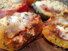 several stuffed peppers with meat and cheese on them