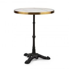 a round table with an iron base and marble top in black, gold and white