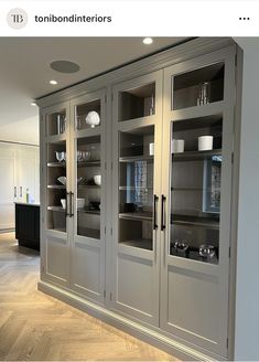 an image of a kitchen setting with glass doors on the front and back cabinets to the side