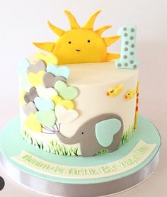 a cake decorated with an elephant and sun