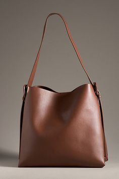 Polyurethane One interior zip pocket Magnetic snap closure Adjustable buckle strap Imported | Buckle Shoulder Bag by Anthropologie in Brown, Women's, Polyurethane Modern Brown Bucket Bag With Adjustable Strap, Classic Shoulder Bag With Adjustable Strap For Errands, Leather Shoulder Bucket Bag With Zipper, Brown Bucket Hobo Bag With Zipper Closure, Everyday Faux Leather Bucket Bag With Adjustable Strap, Versatile Faux Leather Hobo Bag With Adjustable Strap, Everyday Faux Leather Hobo Bag With Adjustable Strap, Brown Shoulder Bag With Zipper For Work, Brown Zipper Closure Shoulder Bag For Work