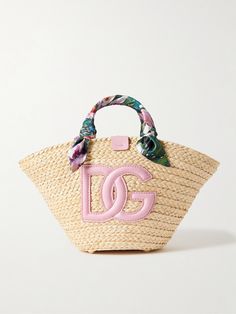 Dolce & Gabbana's 'Kendra' tote is part of the label's 'Flower Power' collection. It's woven from raffia and detailed with a large leather logo, plus floral-print silk-twill wrapped like a scarf around the handles. The joyful design makes it the perfect choice for summer and you'll have plenty of space for your essentials - think phone, wallet and your current book. Spring Bags 2024, Joyful Design, Summer Purse, Luxury Tote Bags, Fancy Bags, Raffia Bag, Silk Twill, Leather Logo, Phone Wallet