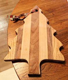 a wooden cutting board sitting on top of a table