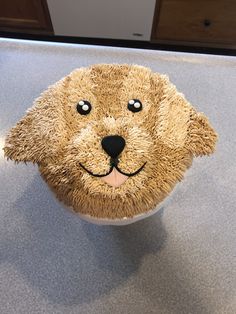 there is a cup cake with a dog's face on it that has been frosted