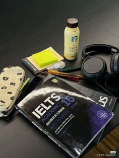 there are headphones, books and other items on the table next to each other