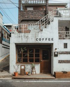 a coffee shop with stairs leading up to it