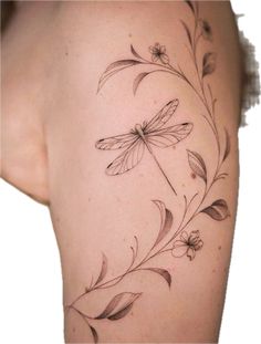 the back of a woman's thigh with flowers and dragonflies on it