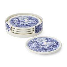 four blue and white plates stacked on top of each other, with an image of a horse in the background