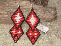 Earrings weaved in the needle in pearls Miyuki Délicas (Japanese quality pearl superior) black, red and white, in brick stitch with a strand C-Lon (special for the weaving). The weaving pearl by pearl in brick stitch is rigid, represent 7 hours of work. Width : 0.98 in Height : 3.07 in The same creation with other color :  https://www.etsy.com/fr/listing/544625686/boucles-doreilles-medaillon-long-bleu?ref=shop_home_active_8 Creation hand-made ! Sending under bubbles to protect your jewels ! Facebook : https://www.facebook.com/blackperleangers/ Warranty without lead, cadmium, nickel Handwoven Black Earrings For Gifts, Traditional Red Beaded Earrings, Elegant Red Handwoven Jewelry, Traditional Red Round Beaded Earrings, Red Black And White Beaded Earrings, Beaded Motorcycle Earrings, Handwoven Red Earrings, Traditional Red Beaded Round Earrings, Adjustable Red Handwoven Earrings