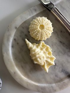 two pieces of cheese sitting on top of a marble plate