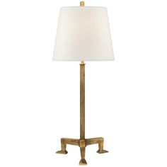 the brass table lamp has a white shade on it