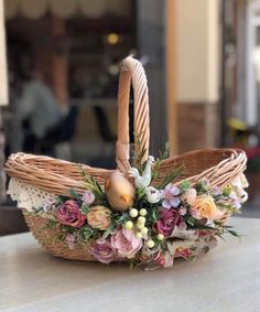 a wicker basket with flowers and eggs in it