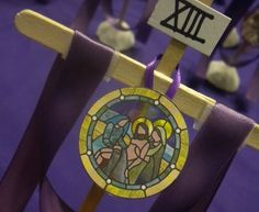 a purple chair with a stained glass window on it's back is in front of other chairs