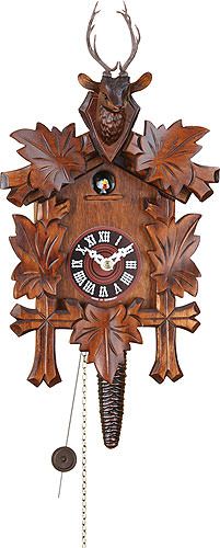 a wooden cuckoo clock with deer head and antlers on it's face is shown