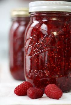 raspberry jam in a mason jar with fresh raspberries