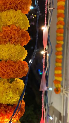 flowers and lights are hanging from the ceiling