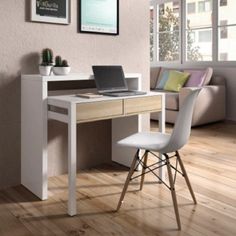 a laptop computer sitting on top of a wooden desk next to a white chair in front of a window