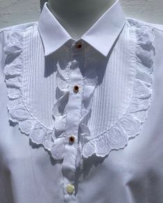 "Authentic Spanish Lace Shirt from Andalucia in Southern Spain  Girl's Vintage  Dress Shirt/Blouse  Formal Equestrian Lace Blouse Age 8-10 Approx Spanish size 32 Measurements: PLEASE CHECK OR IT MIGHT NOT FIT! Chest 34\"(86.5cm).  Sh to sh 15\"(38cm) Collar 12\"(15cm).  Length from nape to hem 23.5\"(60cm) Sleeves from sh to cuff 19.5\"(49.5cm).  P to cuff 16\"(40.5cm) Pretty White Cotton Shirt with Broderie Anglaise Lace Wide Pleated Front with Lace Frill surround 3 Sparkling Ruby Rhinestone Buttons in Gold Tone Clasps All the others are regular white shirt buttons  Excellent Condition Ref: FB9/KSH1 Shipping I usually send with Economy International Post  Delivery time 2-3 weeks approx depending on destination" Classic Long Sleeve Tops With Embellished Collar, Classic Long Sleeve Top With Embellished Collar, Party Tops With Embellished Collar, Classic White Tops For Party, Classic White Party Tops, Classic White Party Top, White Collared Tops With Embellished Collar, White Collared Top With Embellished Collar, White Long Sleeve Tops With Embellished Collar