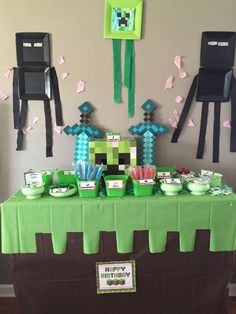 a table topped with paper cutouts and plates filled with desserts on top of it