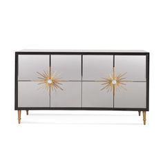 the sideboard with three doors and gold starbursts