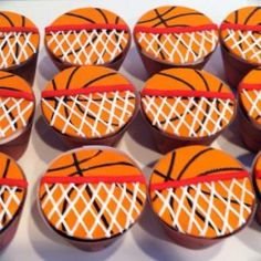 basketball cupcakes with white and orange icing are arranged in a circle on top of each other