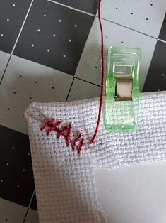 a piece of cloth with a needle and thread attached to it