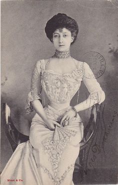 an old black and white photo of a woman in a dress