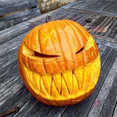 a carved pumpkin sitting on top of a wooden table