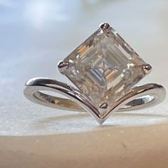 Made A Customer This Ring & I’m So Excited About It. Just Finished And I Had To Share My New Love Of The Asscher Cut With This Ring! Set In Solid Platinum, This 3ct Jewel Eternal Asscher Cut Moissanite Will Hypnotize You With Its Sparkle. The Brilliance Of This Moissanite Is Rated D/Vvs1, Rating It Among The Highest Quality Gemstone You Can Buy. The Setting Is Perfect For Drawing Out The Kaleidoscope Of Light In This Ring. Jewel Eternal Invites You To Inquire About The Customization Of Sizes And 14k White Gold Asscher-cut Diamond White Ring, Platinum Diamond Ring With Vs Clarity, Asscher Cut, White Diamond Ring Vvs Clarity Asscher Cut, Silver Asscher Cut Diamond Ring For Proposal, Silver Diamond Ring For Proposal With Asscher Cut, White Gold Asscher Cut White Topaz Ring, Asscher Cut White Topaz Ring In White Gold, White Asscher Cut Fine Jewelry Rings, Dazzling Sterling Silver Asscher-cut Diamond Ring