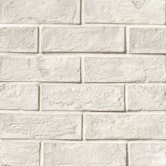 a white brick wall textured with cement