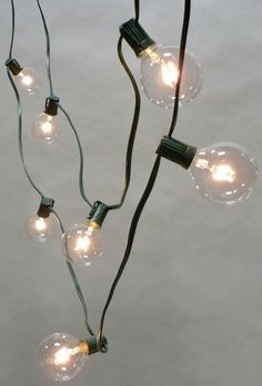 several light bulbs are hanging from a wire