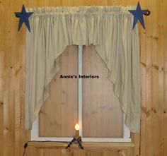 a window with two blue stars hanging from it's side