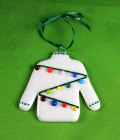 a white ceramic ornament with christmas lights on it