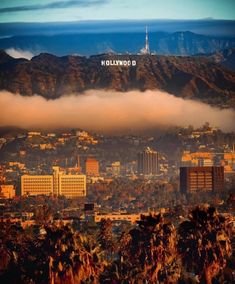 the hollywood sign is in the distance above the city