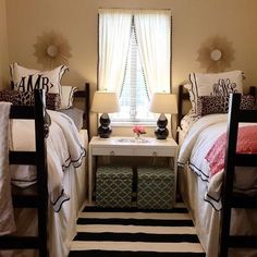 two twin beds in a bedroom with black and white striped rugs on the floor