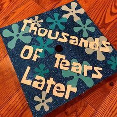 a blue graduation cap that says thousands of years later on the front and sides with snowflakes all over it