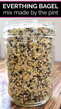 a jar filled with granola sitting on top of a wooden table