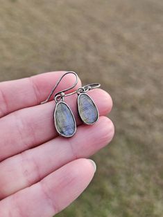 These dangle gemstone earrings feature beautifully flashy rose cut labradorite gemstones dangling from matching handcrafted argentium silver ear wires. The gemstones have been carefully set into handmade argentium silver bezel cups and the pieces have been given a lightly oxidized finish.  These earrings measure approximately 1.25in long x 8mm wide at their widest point.  Follow this link to see my shop: https://www.etsy.com/shop/barebranchjewelry Follow these link to see some of my other gemstone pieces: North star earrings: https://www.etsy.com/listing/1417865688/teal-kyanite-north-star-earrings-teal Orange kyanite ring: https://www.etsy.com/listing/1341334389/orange-kyanite-ring-orange-gemstone-ring Teal Kyanite sunset earrings: https://www.etsy.com/listing/1432075707/moss-teal-kyanite- Teardrop Labradorite Earrings, Handmade Long Drop Labradorite Earrings, Handmade Labradorite Teardrop Earrings, Nickel-free Labradorite Drop Earrings, Labradorite Drop Earrings With Natural Stones, Labradorite Teardrop Earrings As Gift, Labradorite Teardrop Earrings For Gift, Gemstone Labradorite Earrings, Labradorite Gemstone Earrings