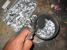 a person is using a spatula to stir food in a pan on a table