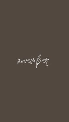 the word november written in cursive writing on a dark background with white ink